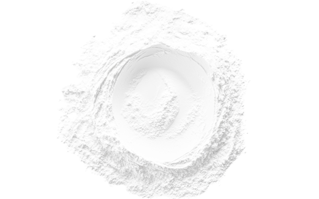 A top-down view of a mound of white powder with a deep circular indentation in the center, isolated on a white background.