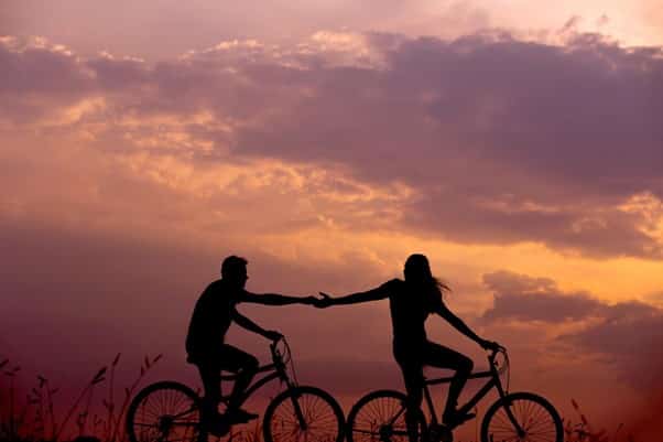 Couple Supporting Each Other Bicycles