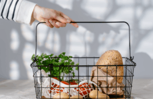 immune health grocery basket with whole grain bread, parsley, tomatoes, and potatoes