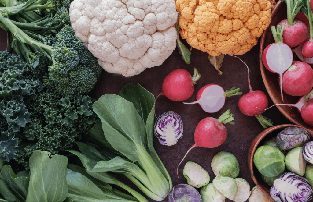 cruciferous vegetables and colorful produce including kale, cauliflower, radishes, and Brussels sprouts for estrogen metabolism and liver support