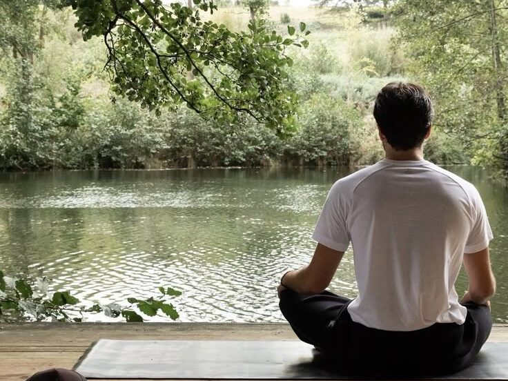 A man engaging in healthy daily routines in natural light.