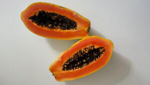 Papaya cut in half showing seeds, often used as a visual metaphor for female reproductive health and cervical wellness.